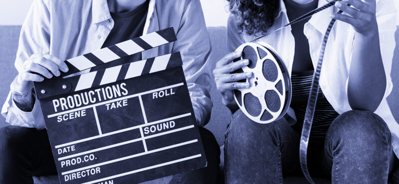 Young women with movie film reel